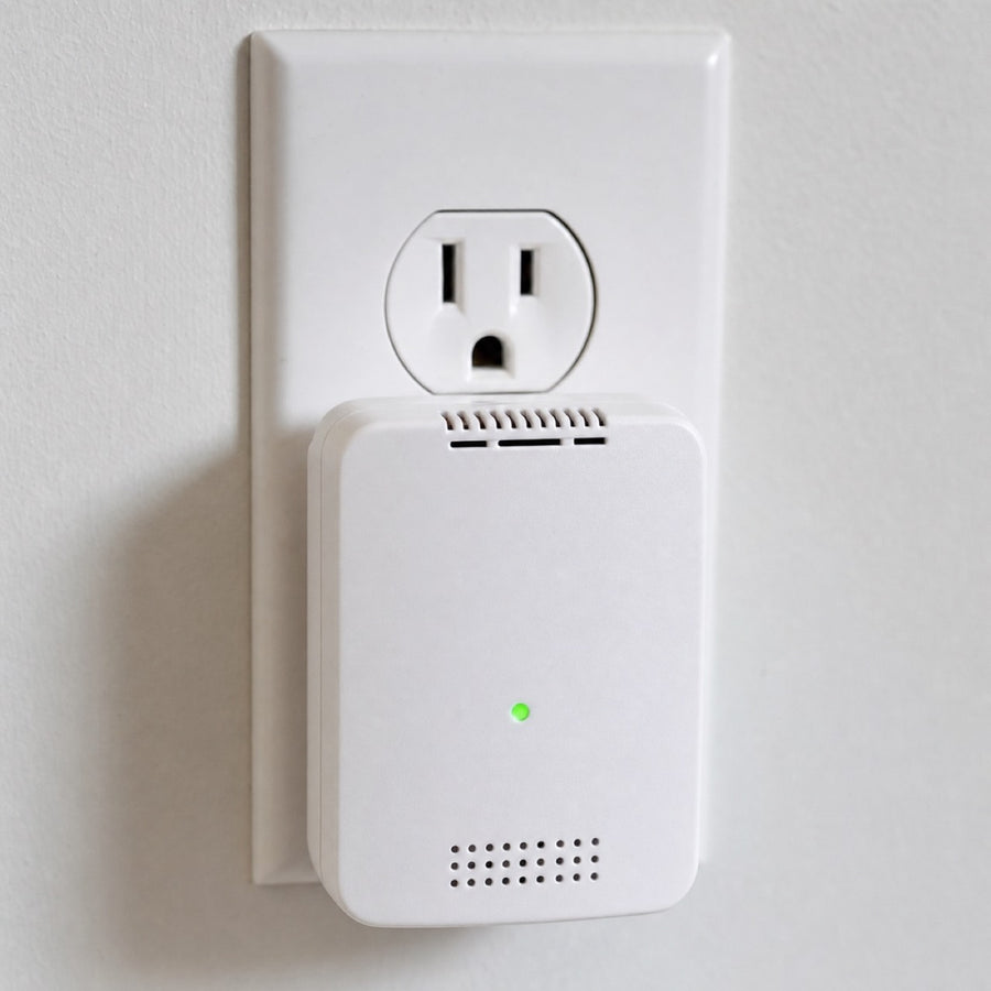 A standard plug-in CO detector. The green light means it has power. It does not mean the air is safe — and it can't smell gas at all.
